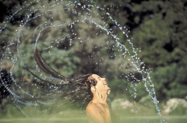 PEOPLE, Women, Woman in a swimming pool flings her wet hair over her head