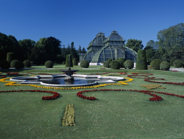AUSTRIA, Vienna, Schonbrunn Palace formal gardens with fountain and the Palm House