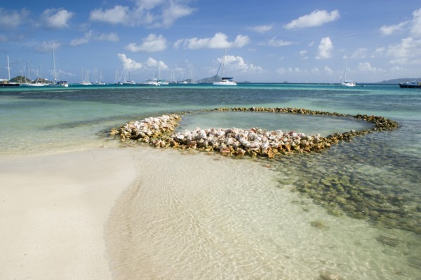 WEST INDIES, St Vincent & The Grenadines, Union Island, Conch shell structures on the beach at