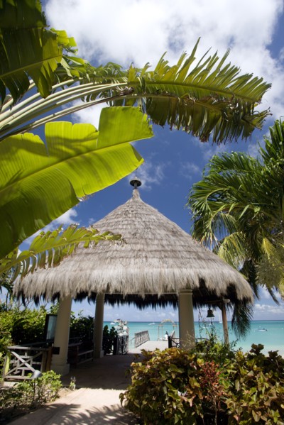 WEST INDIES, St Vincent & The Grenadines, Canouan, Palapa thatched entrance from hotel jetty at