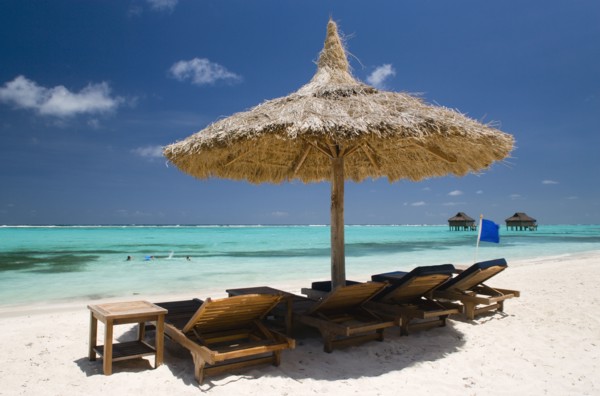 WEST INDIES, St Vincent & The Grenadines, Canouan, Palapa thatched shelter and sunbeds on Godahl