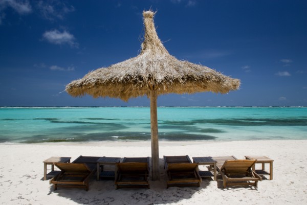WEST INDIES, St Vincent & The Grenadines, Canouan, Palapa thatched shelter and sunbeds on Godahl