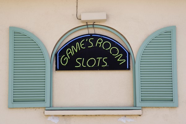 WEST INDIES, Barbados, St James, Gambling rooms neon sign in faked window promoting Slots in