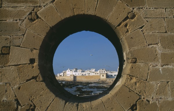 MOROCCO, Essaouira, Fortified coastal town framed in circular opening in wall.