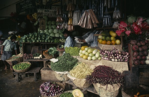 SRI LANKA, Kandy, "Vendors and open fronted stall with display of flowers, vegetables and spices."