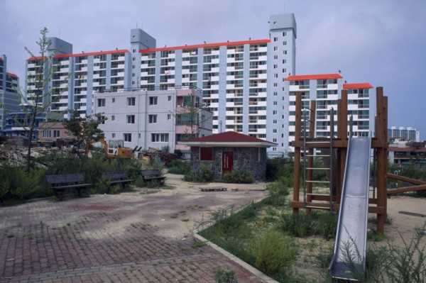 SOUTH KOREA, Sokcho, Large apartment block and childrens playground in east coast fishing port.