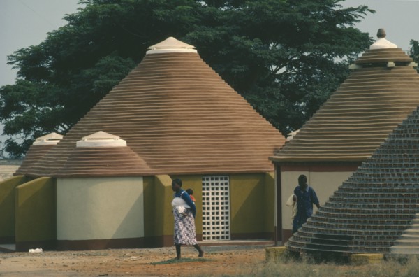 ANGOLA, Tradtional Homes, Women and child outside new village housing.