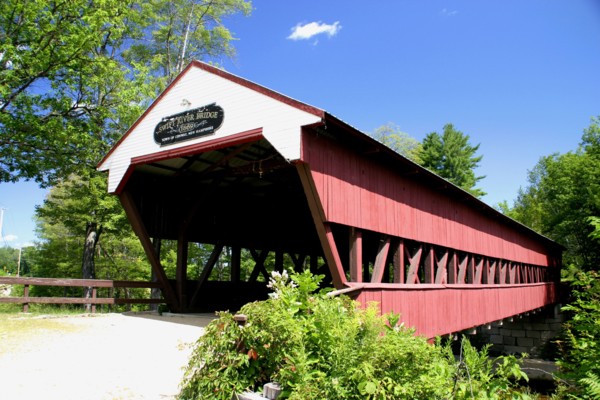USA, New Hampshire, Conway, "Swift River Covered Bridge, wooden structure over water."