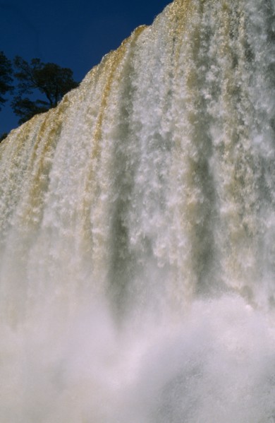 ARGENTINA, Iguazu Falls, Looking up at the water pouring over the edge with water spray.