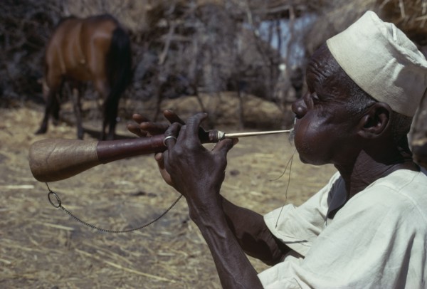 CHAD, Music, "Musician playing a shawm, a traditional double reed instrument"