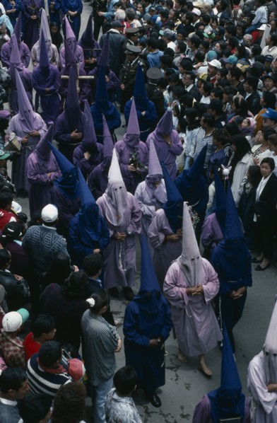 ECUADOR, Quito, Good Friday procession in Plaza San Francisco.  Penitents wearing purple robes and