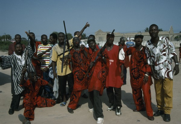 GHANA, Accra, Burial of an engineer.  The Asafo royal family guard call on the spirit of the dead