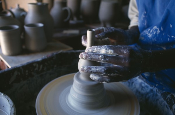 MALAWI, Dedza, Dedza Potteries producing Fair Trade goods for export.  Cropped view of potter