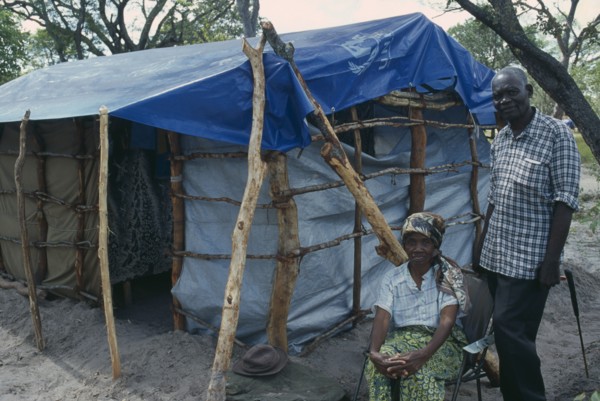 ZAMBIA, Mayukwayukwa Camp, Elderly couple beside shelter in camp for Angolan refugees.
