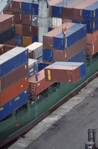 IVORY COAST, San Pédro, Containers being unloaded from vessel docked at San Pédro port.  Worker