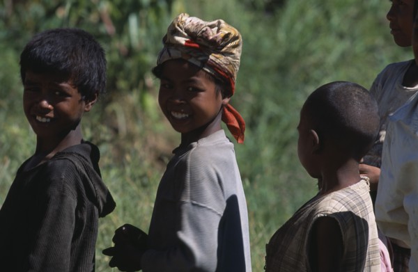 MADAGASCAR, People, Children , Portrait of a girl wearing a headscarf standing amongst two other