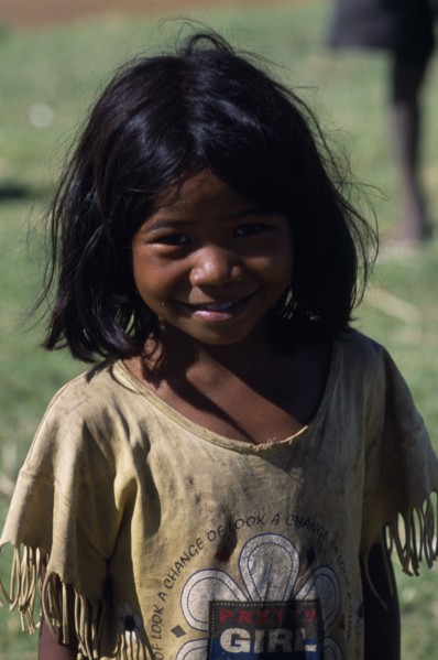 MADAGASCAR, Peope, Children, Portrait of a smiling child wearing a dirty t shirt printed with the