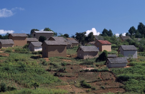 MADAGASCAR, Architecture, Road to Ambalavao. Thatched huts set into hillside