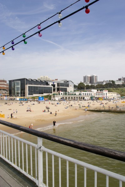 ENGLAND, Dorset, Bournemouth, The East Beach from the pier with seafront restaurants and bars.