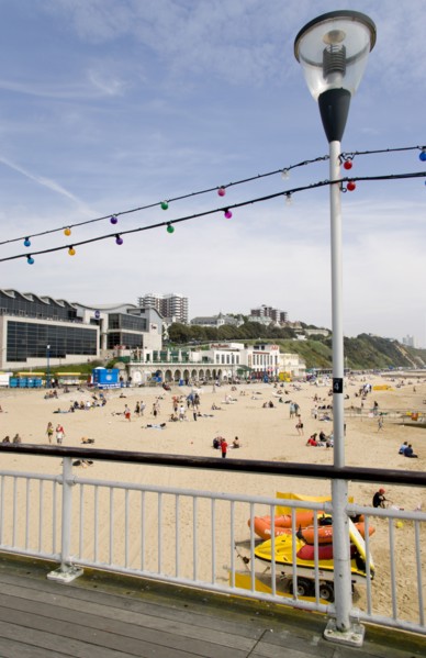 ENGLAND, Dorset, Bournemouth, The East Beach from the pier with seafront restaurants and bars.