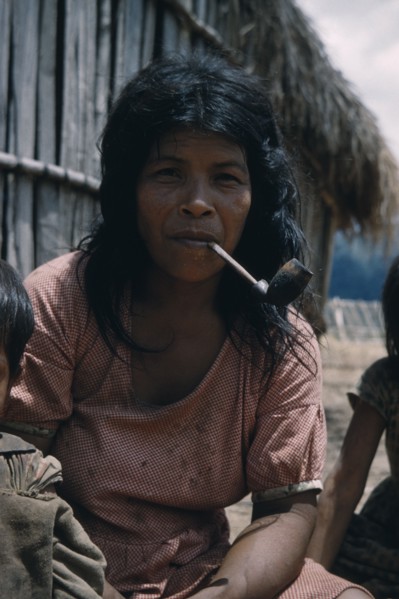COLOMBIA, Sierra de Perija, Yuko - Motilon , Mother smoking tobacco in a clay pipe