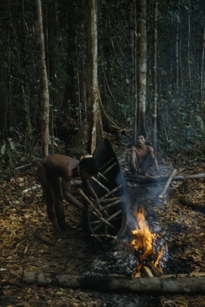 COLOMBIA, Vaupes Region, Tukano Tribe, "2 men making a canoe from a single tree trunk. After