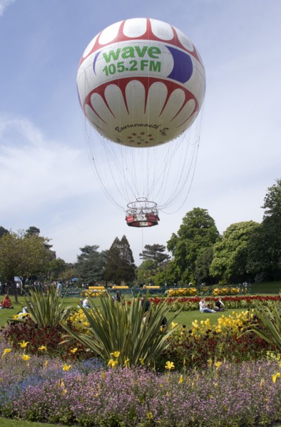 ENGLAND, Dorset, Bournemouth, The Bournemouth Eye balloon lifting off in The Upper Pleasure Gardens