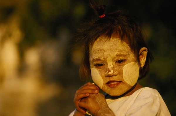 MYANMAR, Pagan, "A young girl near Bupaya Pagoda, with white painted face, circles on her cheeks."