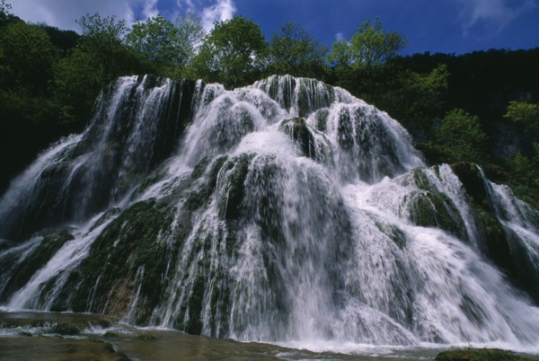 FRANCE, Franche Comte, Ciaquc de Baume, Jura. Waterfall cascading over rocks