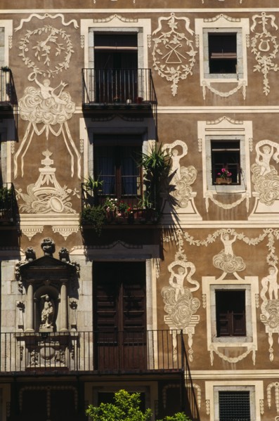 SPAIN, Catalonia, Barcelona, Decorated exterior of flats on the Plaza Delfi with potted plants and