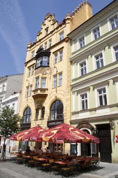 CZECH REPUBLIC, Bohemia, Prague, Tables and umbrellas on the pavement outside a cafe in a