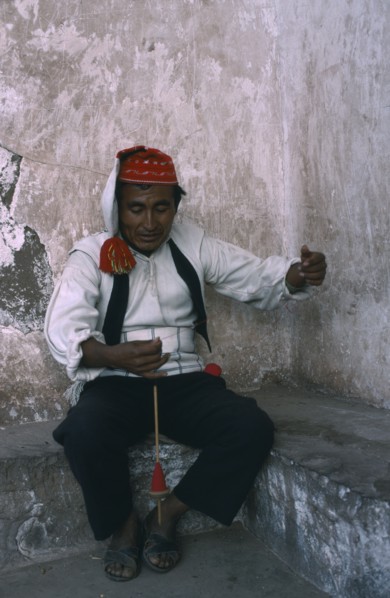 PERU, Puno, Lake Titicaca, Taquile man spinning wool.