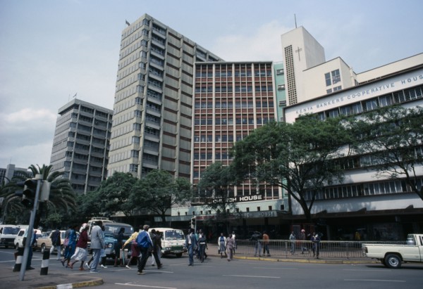 KENYA, Nairobi, "Downtown Nairobi with people crossing road, waiting traffic and high rise