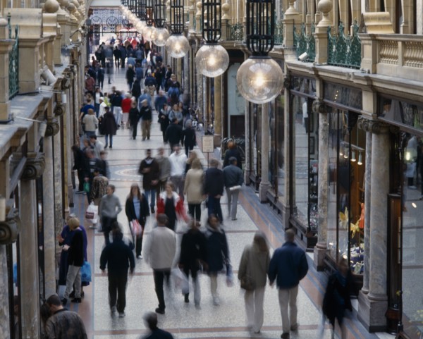 ENGLAND, Yorkshire, Leeds, Leeds County Arcade interior with shoppers walking along marbled walkway