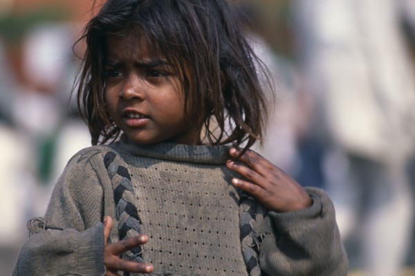 INDIA, Delhi, "Portrait of young street girl wearing dirty,oversized jumper.  Rtnd 2 VKB 15/5/2009"