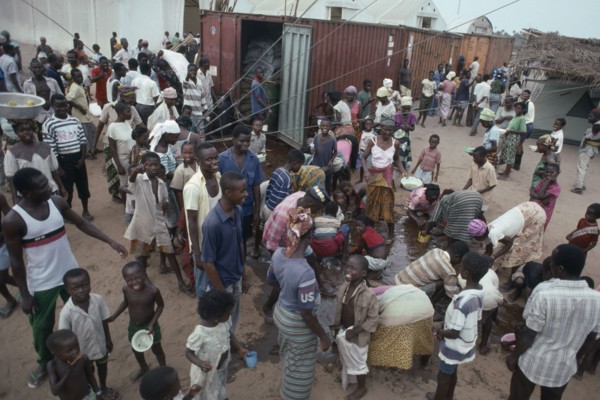 LIBERIA, War, People displaced by civil war attempting to recover cooking oil spilt in queue for UN