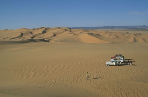 LIBYA, Sahara Desert, Tourists with four by four vehicles in desert landscape.
