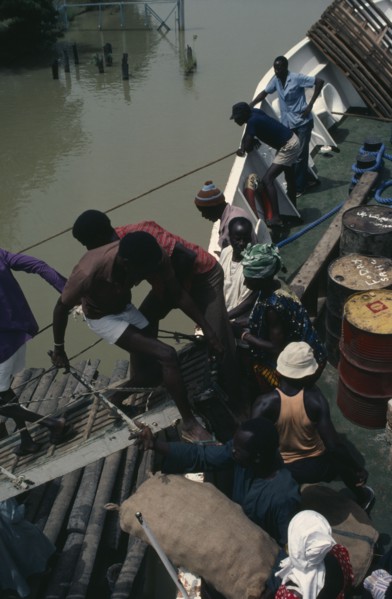 GAMBIA, Transport, People boarding boat on the River Gambia.