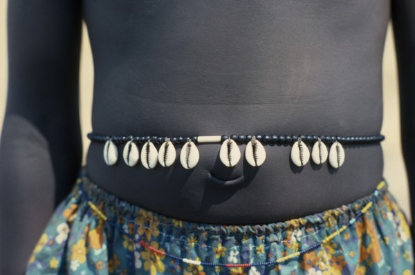 SUDAN, Tribal People, Cropped shot of Dinka girl wearing cowrie shell belt to indicate puberty.