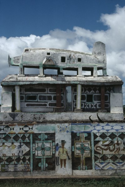 MADAGASCAR, Art, Part view of Mahafaly highly decorated tomb with carved effigy of aeroplane on