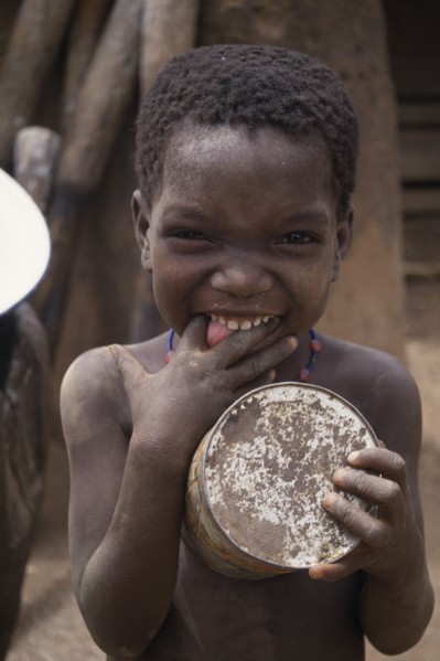 GHANA, North, People, Portrait of small child pulling face with fingers in mouth.