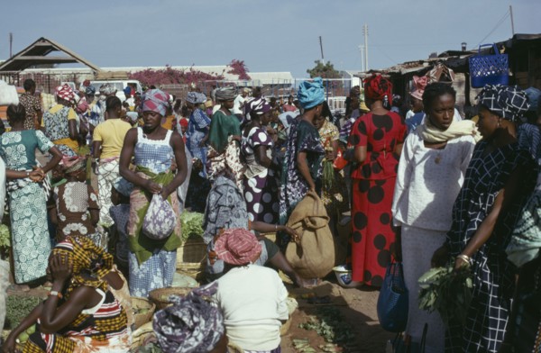 GAMBIA, Banjul, Women at market wearing brightly coloured clothes
