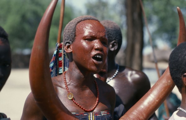 SUDAN, Tribal People, Dinka girl with red painted face at festival celebrating the return of cattle