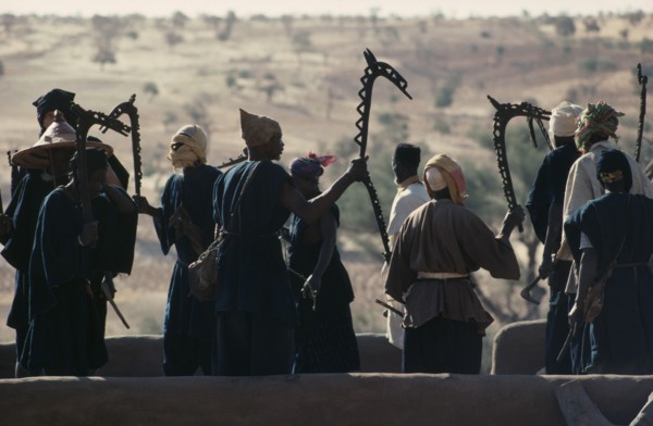 MALI, Ceremony, Dogon men carrying carved wooden staffs symbolic of ancient Dogon society