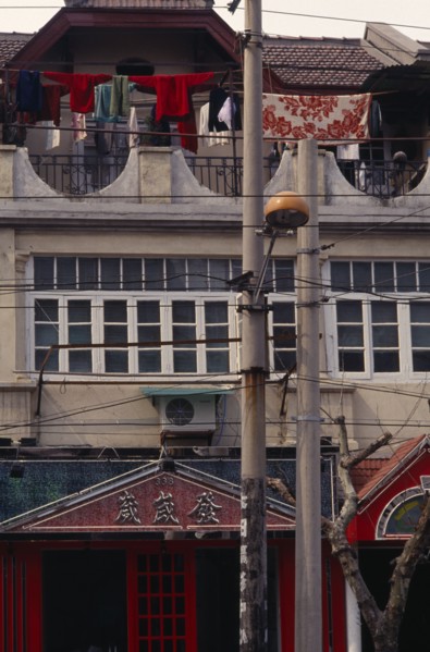 CHINA, Shanghai, Detail of Colonial architecture with washing hung out to dry on upper balcony.
