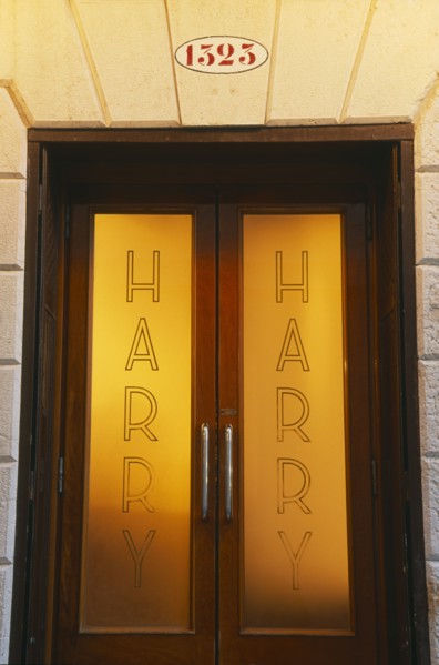 ITALY, Veneto, Venice, Door of Harry’s Bar with name etched on the frosted glass.