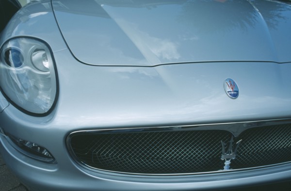 TRANSPORT, Road, Cars, Detail of silver Maserati with emblem and front light.