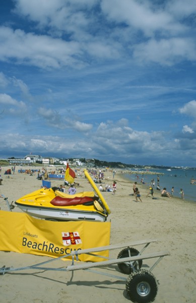 ENGLAND, Dorset, Sandbanks, Lifeboats Beach Rescue banner and Jetski on sandy beach.