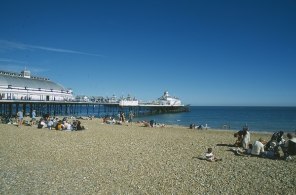 ENGLAND, East Sussex, Eastbourne, View from occupied shingle beach towards Pier