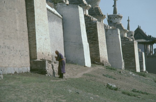 MONGOLIA, Central Gobi Province, Karakorum, Pilgrim circumnavigating city walls on site of ancient